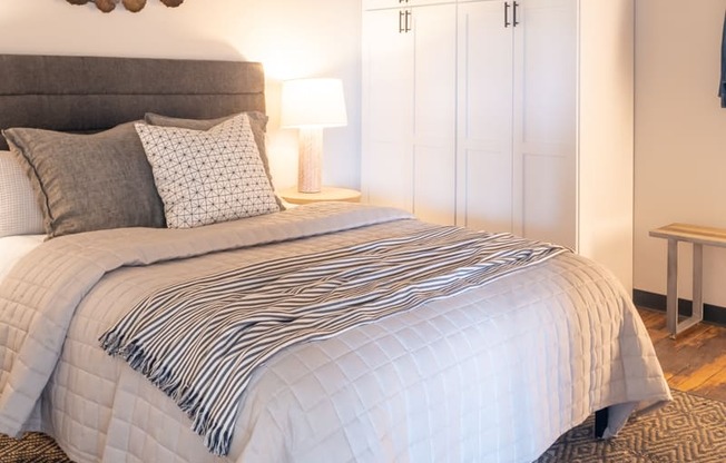 a bedroom with a large bed and a white wardrobe at The Draper, Missouri