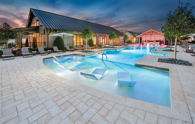 night view of pool with seating