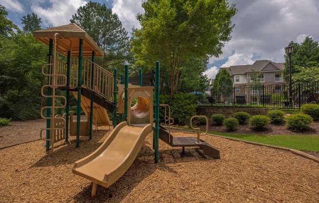 a playground with a slide and a swing set