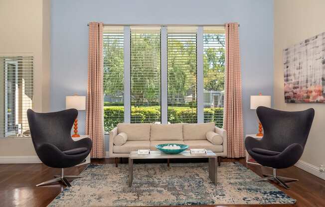 a living room with a couch and two chairs