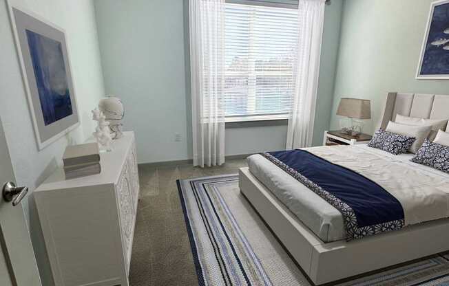 A bedroom with a bed, nightstand, and a ceiling fan.