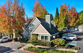 A house with a grey roof and a white car parked in front.