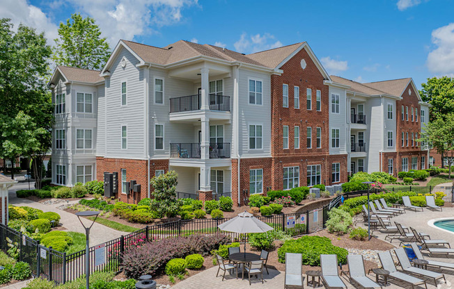 A large apartment complex with a pool and patio area.