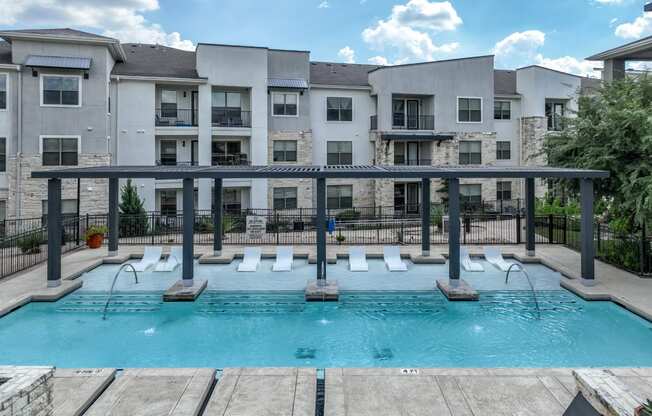 swimming pool with aqua tanning ledge at The Allure apartments