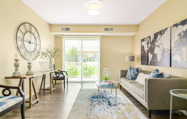 a living room with beige walls and a large clock on the wall