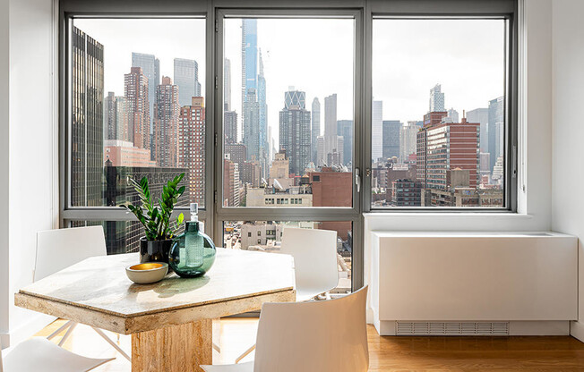 Midtown West two bedroom apartment with dining area, floor to ceiling windows, and city views for re