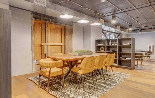 a dining room with a wooden table and chairs