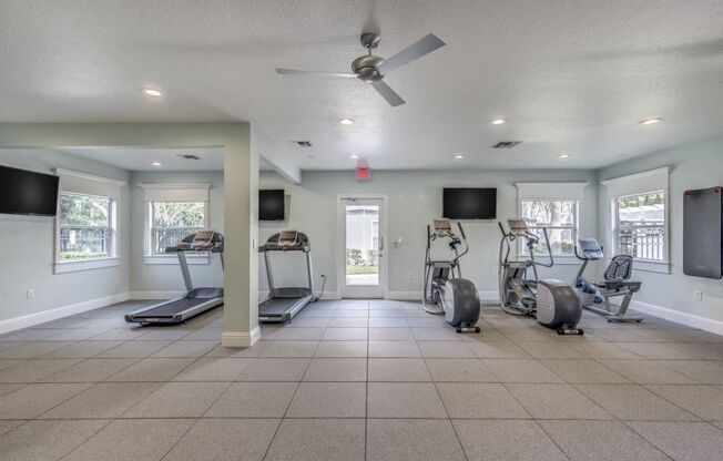 Fitness center with three tv's and cardio machines