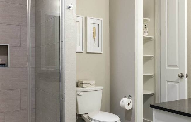 bathroom with glass-framed shower doors at Tinsley on the Park apartments