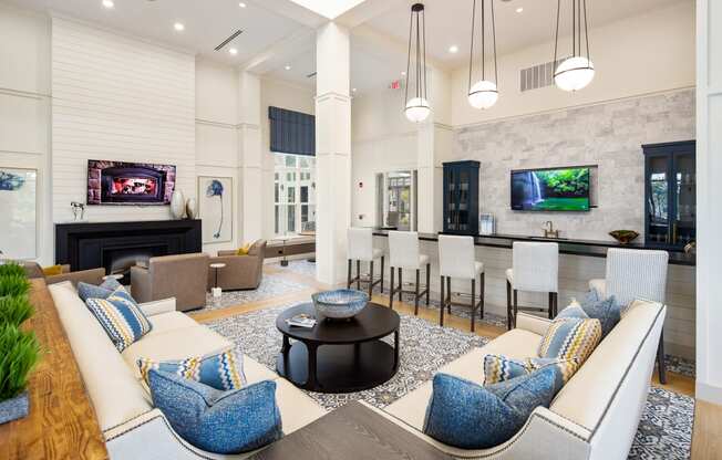 Resident clubhouse with lounge seating, TVs, and communal kitchen at The Highland in Augusta, GA