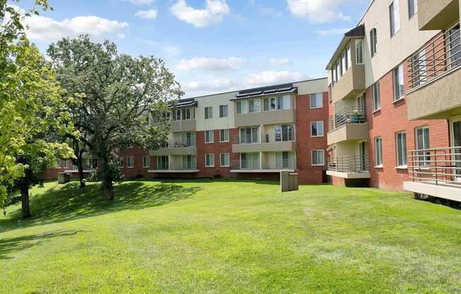 A grassy area in front of apartment buildings.