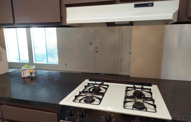 a stove top oven sitting inside of a kitchen