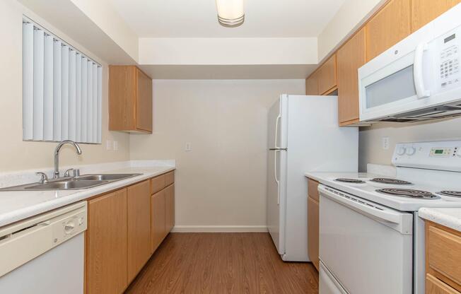 a kitchen with a stove sink and refrigerator