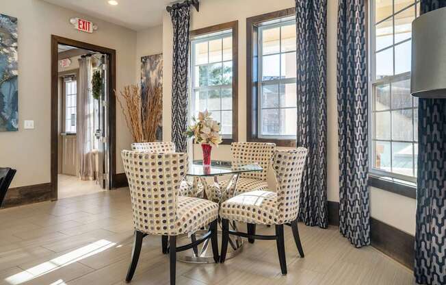 A dining room with a table set for two.