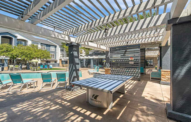Outdoor Ping Pong Table and Pool Area at Allure North Dallas Apartments in Dallas, TX.