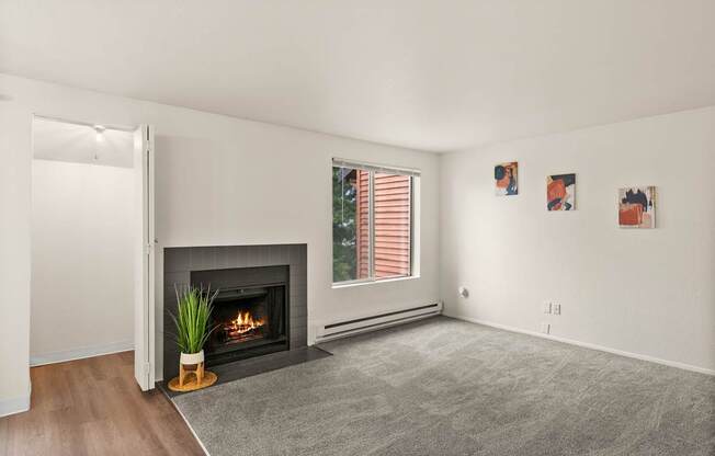 A living room with a fireplace and a rug.