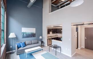a living room with a couch and a table at Cherry Street Lofts, Bridgeport, Connecticut