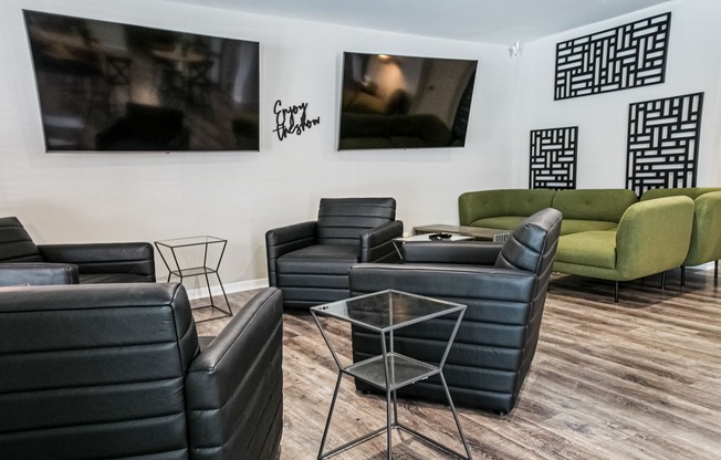 Community lounge area with sitting chairs and televisions