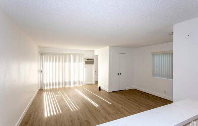 A room with wooden floors and white walls.