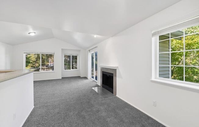 the living room and kitchen of a house with a fireplace