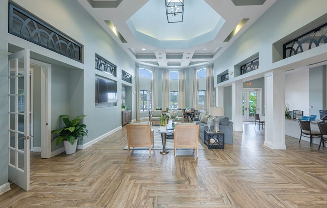 a large living room with a large window and a coffered ceiling