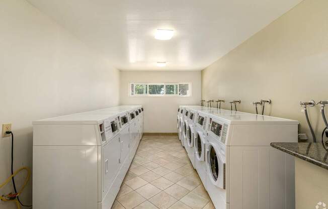 a washer and dryer laundry room with two sets of washing machines