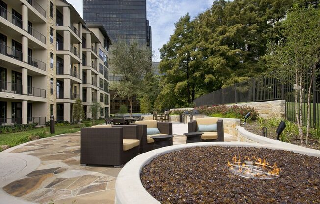 a fire pit in the middle of a courtyard with furniture