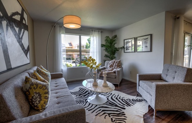 a living room with a zebra rug and couches