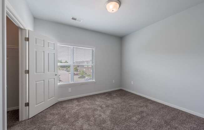 an empty room with a door and a window