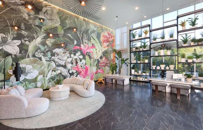 a lobby with a large wall mural of flowers and plants