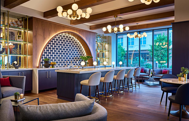 the lobby of a hotel with a bar and tables and chairs at Dey & Bergen, Harrison, NJ