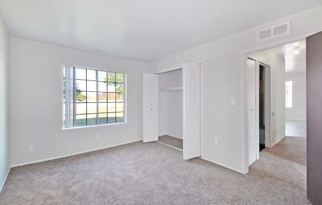 Comfortable bedroom with ample closet space at Farmbrooke Manor Apartments Clinton Township MI