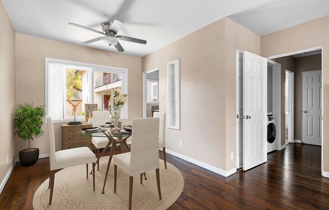 a dining room with a table and chairs and a ceiling fan