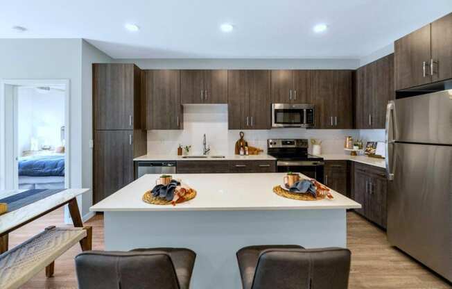 Model kitchen with light colored countertops at Glen 91 Apartments in Glendale, AZ