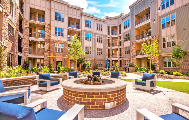 an outdoor courtyard with a fire pit and lounge chairs at Artesia Big Creek, Alpharetta, GA, 30005