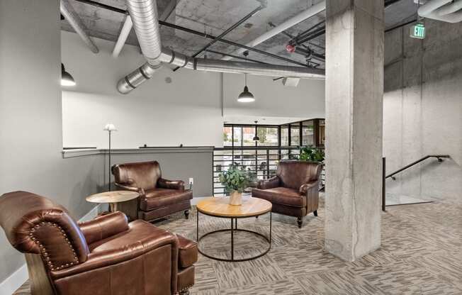 a living room with leather chairs and a table