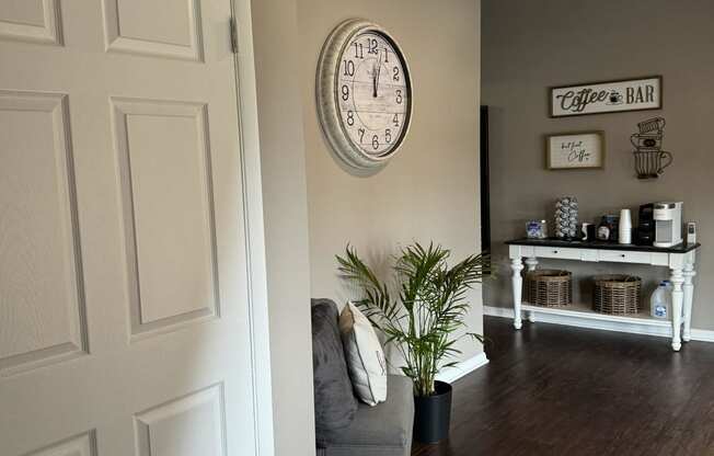 a living room with a chair and a clock on the wall