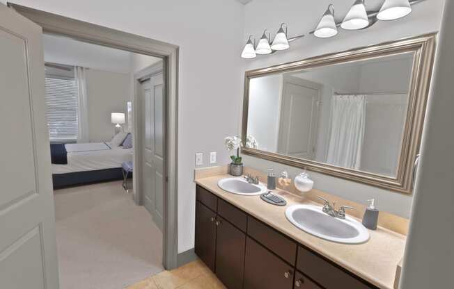 a bathroom with two sinks and a large mirror