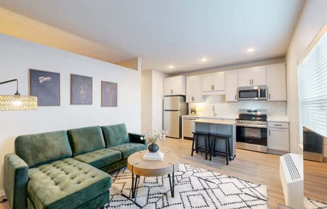 A living room with a green couch and a coffee table.