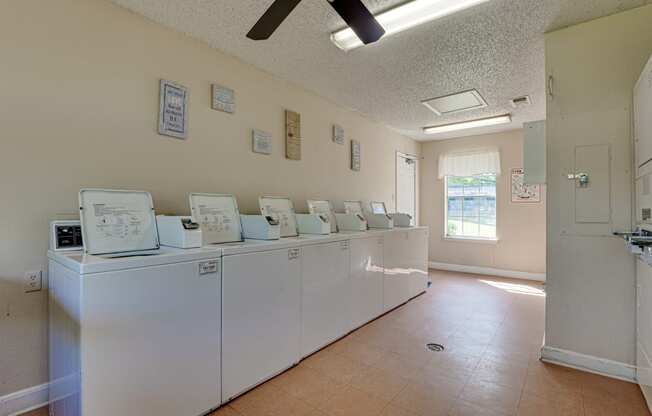 Laundry room with plenty of washers and dryers  at Arbors Of Cleburne, Texas, 76033