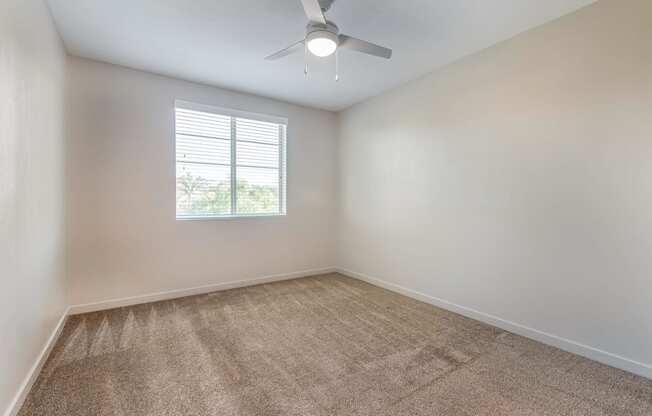 an empty room with a ceiling fan and a window at Metro Gateway, Riverside, CA