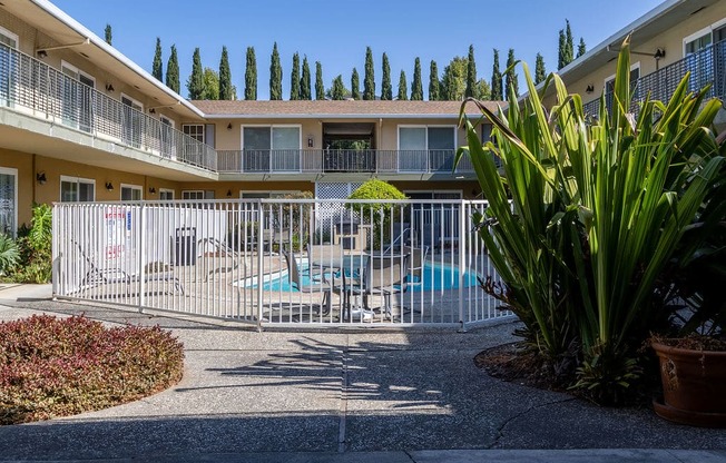 a building with a pool and a fence in front of it