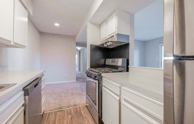 A kitchen with white cabinets and stainless steel appliances.