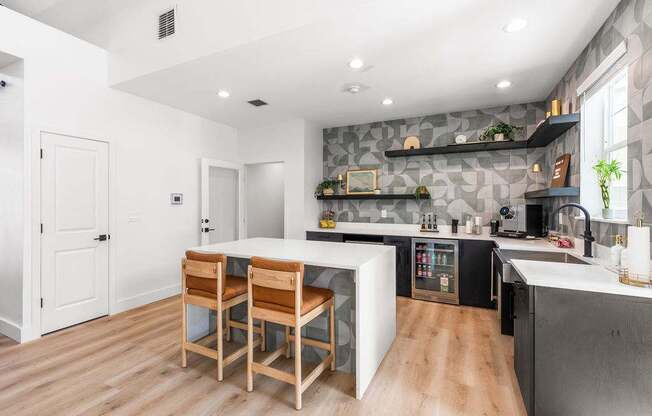 A kitchen with a table and chairs in the middle of the room.