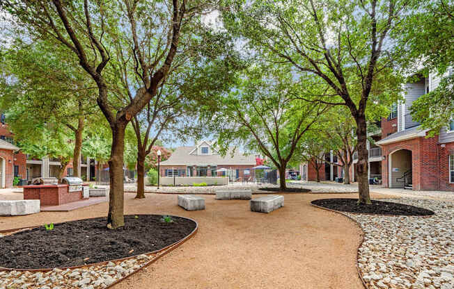 A tree-lined walkway leads to a building.