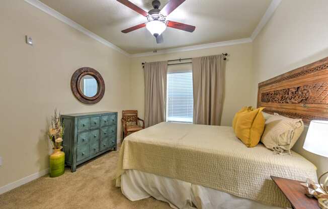 the master bedroom has a large bed and a ceiling fan at Hacienda Club, Jacksonville, FL, 32256