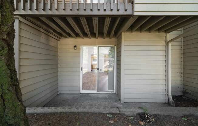 the front door of a house with a ramp and a balcony