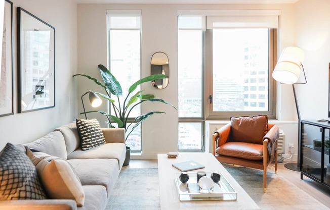 a living room with a couch and a chair and a table at The Lively, Jersey City New Jersey