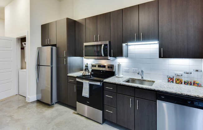 Kitchen with Stainless Steel Appliances and In-home Washer and Dryer