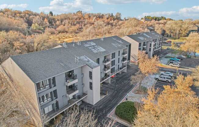 Apartment complex with a parking lot in front.